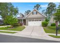 Traditional home features a two-car garage, manicured lawn, and tasteful landscaping at 207 Brutus Ln, Summerville, SC 29485