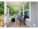 Charming front porch featuring a bench and decorative pillows at 208 General Moultrie Dr, Bonneau, SC 29431