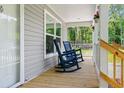 Relaxing front porch with rocking chairs, providing a cozy outdoor space at 208 General Moultrie Dr, Bonneau, SC 29431