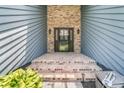 Inviting home entrance featuring brickwork and elegant outdoor lighting at 211 White Church Ln, Summerville, SC 29485