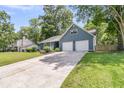 Picture of blue home's exterior, featuring a well kept lawn and two car garage at 211 White Church Ln, Summerville, SC 29485