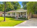 Charming brick home featuring a well-manicured green lawn and concrete driveway at 230 Azalea Ct, Moncks Corner, SC 29461