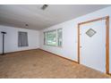 Bright living room features carpet, a large window, and neutral walls at 2567 Mona Ave, Charleston, SC 29414