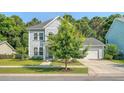 Attractive two-story home with a well-maintained lawn and mature tree enhancing curb appeal at 2652 Private Lefler Dr, Johns Island, SC 29455