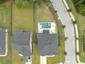 Aerial view of home and backyard with pool and jacuzzi in fenced in yard with sidewalk and street at 2802 Cavalcade Cir, Johns Island, SC 29455