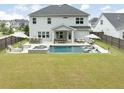 Expansive backyard featuring pool, jacuzzi, outdoor kitchen, lounge chairs, and patio seating at 2802 Cavalcade Cir, Johns Island, SC 29455