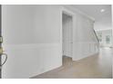 Bright entryway featuring hardwood floors, wainscoting, and a glimpse of the staircase to the next level at 2820 Merriams Dr, Charleston, SC 29414
