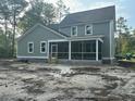 Back of home featuring a screened-in porch perfect for outdoor relaxation and entertaining at 3006 Sweetwater Ln, Awendaw, SC 29429