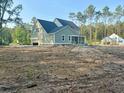 View of a two-story home with an attached garage and screened in porch at 3006 Sweetwater Ln, Awendaw, SC 29429
