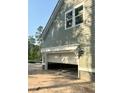 Open garage showcasing ample space and natural light, providing convenient parking at 3006 Sweetwater Ln, Awendaw, SC 29429