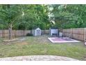 Spacious backyard featuring a privacy fence, green lawn, two storage sheds and patio furniture at 3009 Mapleleaf Dr, Moncks Corner, SC 29461