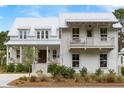 Stunning exterior displaying a charming porch, a balcony above, and meticulously maintained landscaping at 3023 Eventide Dr, Johns Island, SC 29455