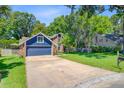Attractive home with an attached garage, a lush green lawn, and well-maintained landscaping at 310 Christiee Ct, North Charleston, SC 29418
