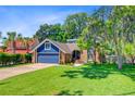 Charming two-story home features a two-car garage and a well-manicured lawn with mature trees at 310 Christiee Ct, North Charleston, SC 29418