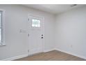 Bright entryway with white trim, light walls, and wood-look flooring at 3231 Stonehaven Dr, North Charleston, SC 29420