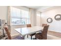Open dining area with large window, a table, four chairs, and tasteful decorations at 325 Willow Run Dr, Summerville, SC 29486