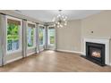 Bright, airy living room featuring large windows, fireplace, and contemporary lighting, offering ample natural light at 327 Megans Bay Ln, Charleston, SC 29492