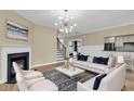 Inviting living room with fireplace, stylish furniture, and modern lighting, perfect for relaxation at 327 Megans Bay Ln, Charleston, SC 29492