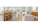 Open-concept living room and dining area with wood floors, lots of natural light, and stylish decor at 329 Willow Run Dr, Summerville, SC 29486