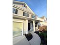 Charming two-story home with a well-manicured lawn, inviting front porch, and attached garage at 332 Southern Sugar Ave, Moncks Corner, SC 29461