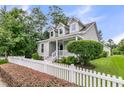 Beautiful home with a white picket fence and lush green lawn at 3408 Salterbeck St, Mount Pleasant, SC 29466