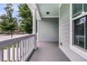 Spacious front porch with neutral gray flooring and white pillars at 3408 Salterbeck St, Mount Pleasant, SC 29466