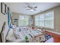 Bright bedroom with two twin beds, decorative bookshelves, and natural light at 3805 Adrian Way, Mount Pleasant, SC 29466