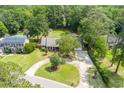 Aerial view of the home showing a large yard, circular driveway, swimming pool and lush landscaping at 44 S Basilica Ave, Hanahan, SC 29410