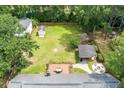Aerial view of the large fenced in backyard featuring a large deck, outdoor kitchen, a fire pit, and ample green space at 44 S Basilica Ave, Hanahan, SC 29410