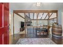 Inviting living room featuring an open floorplan, vaulted ceilings with wood beams, and a cozy fireplace at 44 S Basilica Ave, Hanahan, SC 29410