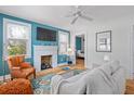 Comfortable living room with a white fireplace, hardwood floors, and stylish furnishings at 4932 N Rhett Ave, North Charleston, SC 29405