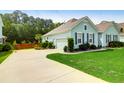 Exterior view of a home featuring a well-kept lawn and a driveway leading to the garage at 5509 Alpine Dr, Summerville, SC 29483