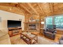 Inviting living room featuring a stone fireplace, hardwood floors, comfortable seating, and natural light at 5519 Jefferies Hwy, Walterboro, SC 29488