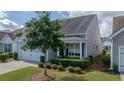 Beautifully landscaped front yard and a two-car garage on this lovely home at 105 Harbor Trace Ln, Summerville, SC 29486
