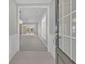 Open foyer featuring tile flooring, wainscoting and chandelier with views into the living space with sliding glass doors at 109 Billowing Sails St, Summerville, SC 29486