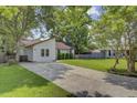 Quaint one-story home with a long driveway, complemented by a lush green lawn and mature trees at 109 Salem Ct, Summerville, SC 29486