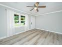 Bright living room with new flooring, a ceiling fan, and a large window overlooking the front yard at 114 Bailey Dr, Summerville, SC 29485