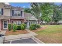 Charming two-story townhome with well-maintained landscaping and inviting front entrance at 117 Macy Cir, Goose Creek, SC 29445