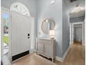 Inviting entryway with light blue walls, wood floors, bright natural light, and attractive decor at 1179 Holly Bend Dr, Mount Pleasant, SC 29466