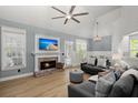 Stylish living room with brick fireplace, comfortable seating, modern lighting, and plank flooring at 1179 Holly Bend Dr, Mount Pleasant, SC 29466