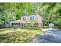Two-story brick home boasts mature trees, driveway, and detached garage at 123 Azalea Dr, Summerville, SC 29485