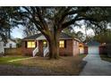 Charming brick home with a well-manicured front yard and a detached garage at 1235 Sunset Dr, Charleston, SC 29407