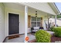 Inviting front porch with cozy seating and a hanging hammock, perfect for relaxing outdoors at 1302 Aubry Dr, Moncks Corner, SC 29461