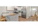 Modern kitchen with white cabinets, stainless steel appliances, and granite countertops at 141 Haventree Ct, Summerville, SC 29486