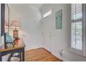 Welcoming entryway showcasing wood floors, elegant decor, and a sign with beach house rules at 1647 Marsh Harbor Ln, Mount Pleasant, SC 29464