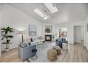 Bright and airy living room featuring a cozy fireplace, skylights, and stylish furnishings at 1705 Bassett Ct, Charleston, SC 29412