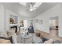 Comfortable living room showcasing a fireplace, ceiling fan, and sliding glass doors at 1705 Bassett Ct, Charleston, SC 29412