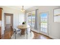 Bright dining area with round table, white chairs, and doors leading to the outdoor deck and waterfront view at 1713 Pimlico Blvd, Moncks Corner, SC 29461