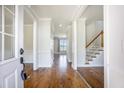 Inviting foyer featuring hardwood floors and a staircase leading to the upper level of the home at 1713 Pimlico Blvd, Moncks Corner, SC 29461