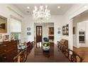 Formal dining room with a large wooden table, chandelier, and view to the front entry at 18 Fernandina St, Mount Pleasant, SC 29464